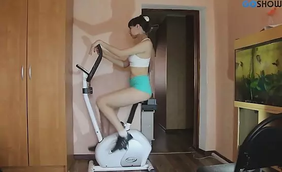 Fit Brunette Masturbates on Stationary Bike with Sex Toys